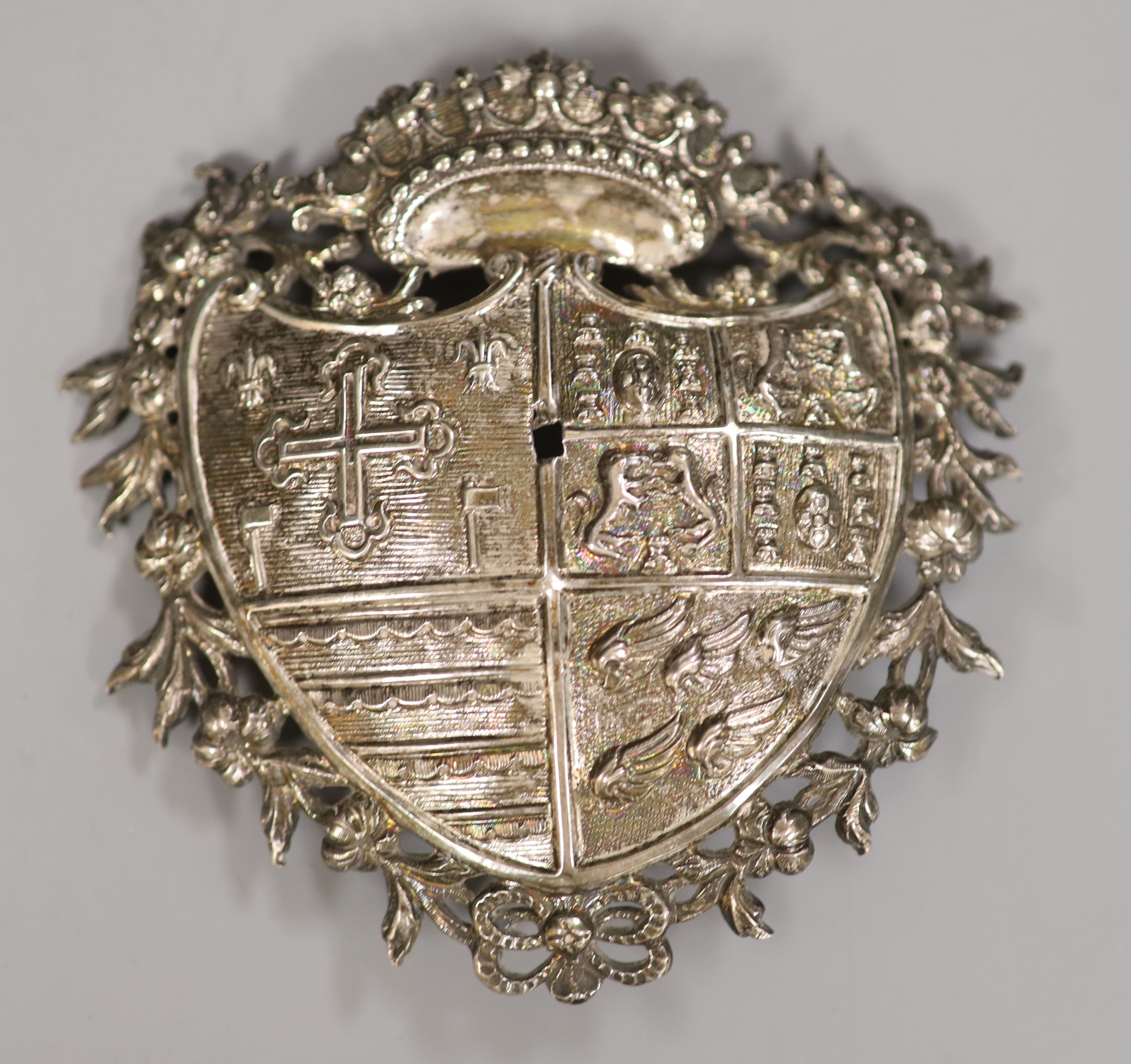 A continental white metal shield shaped badge (hole to centre), 10.4cm, 44 grams.